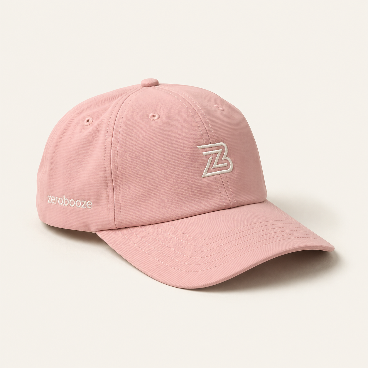 Pink Zero Booze cap with white ZB embroidery on a warm-white background